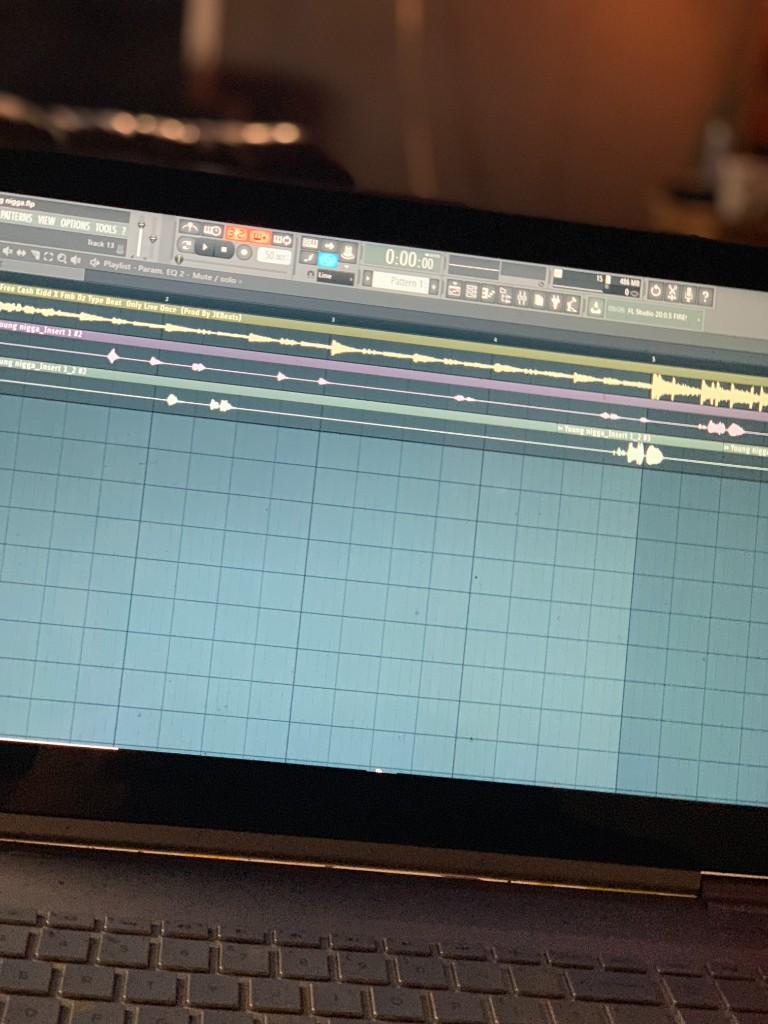 A laptop screen showing an FL Studio playlist with vocal takes lined up across the tracks