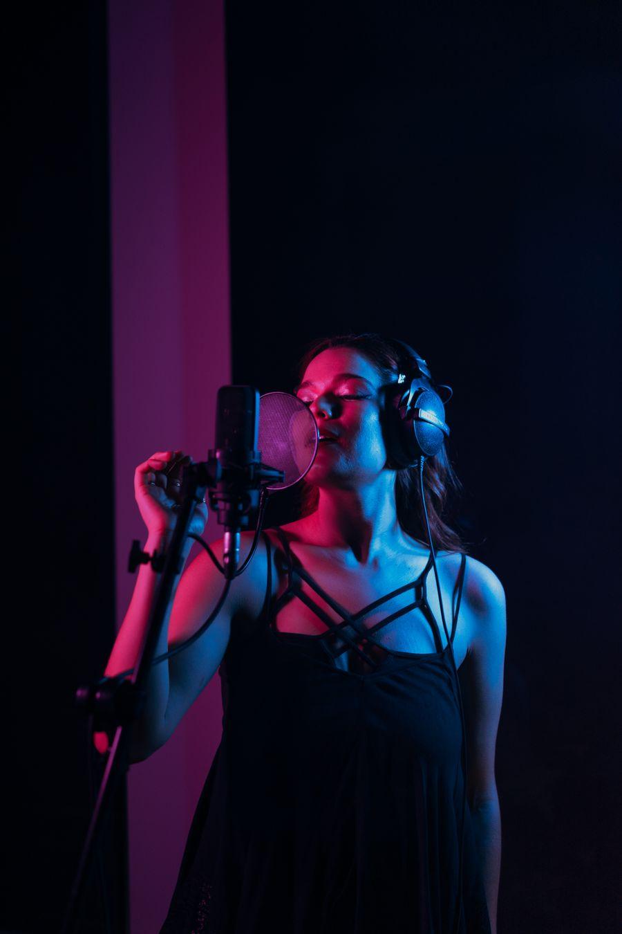 Someone singing into a studio microphone